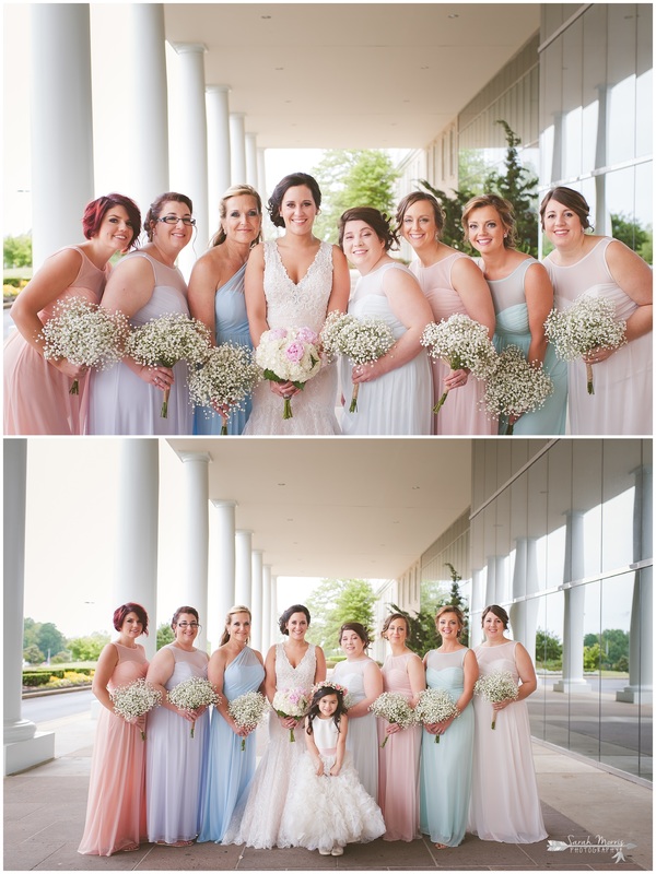 Bride and bridesmaids, wearing mismatched bridesmaid dresses under the portico at Bellevue Baptist Church
