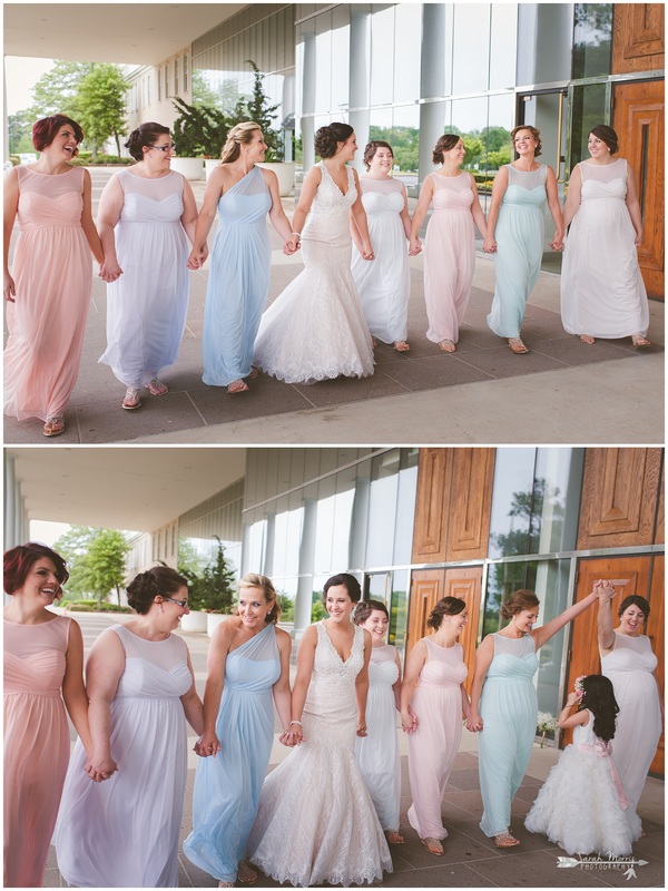 Bride and bridesmaids, wearing mismatched bridesmaid dresses under the portico at Bellevue Baptist Church