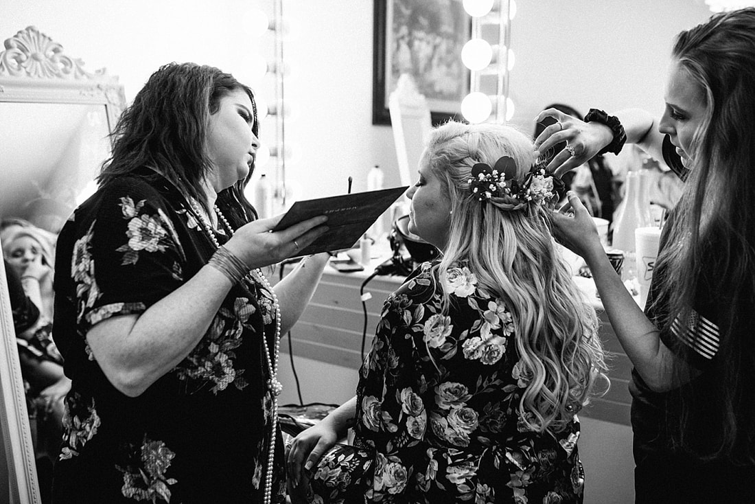 bride getting her hair and makeup done  at the wedding barn in arkansas