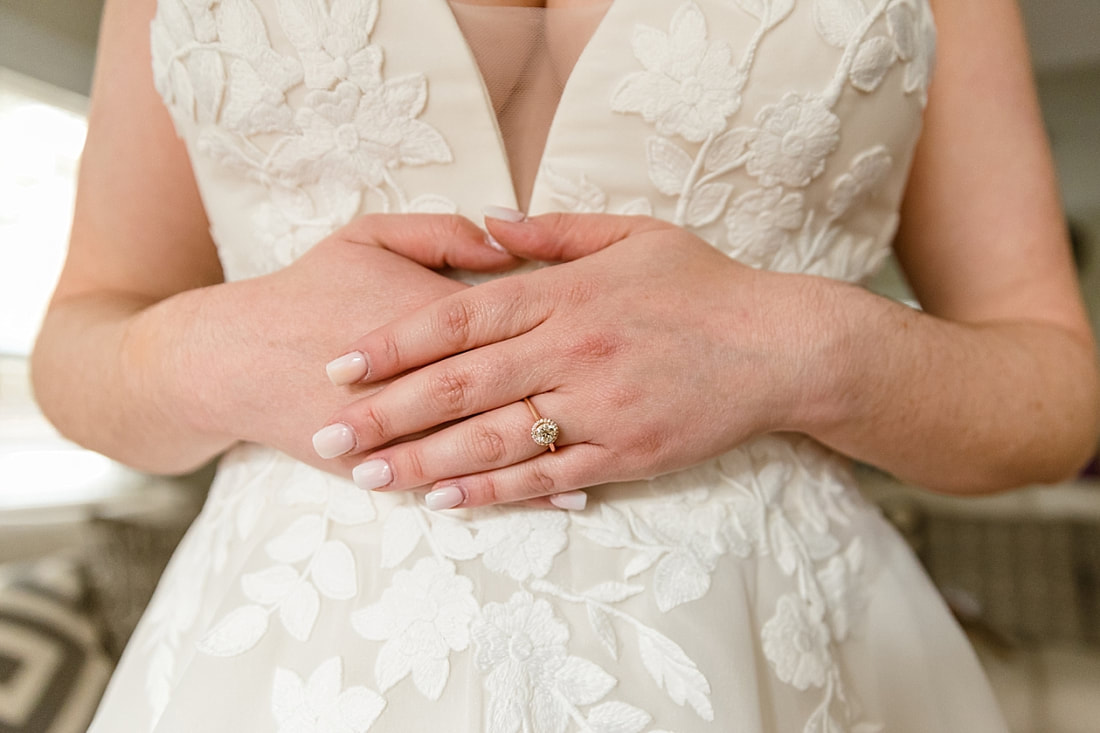 close up of bride's engagement ring on her Maggie Louise Bridal Wedding Gown