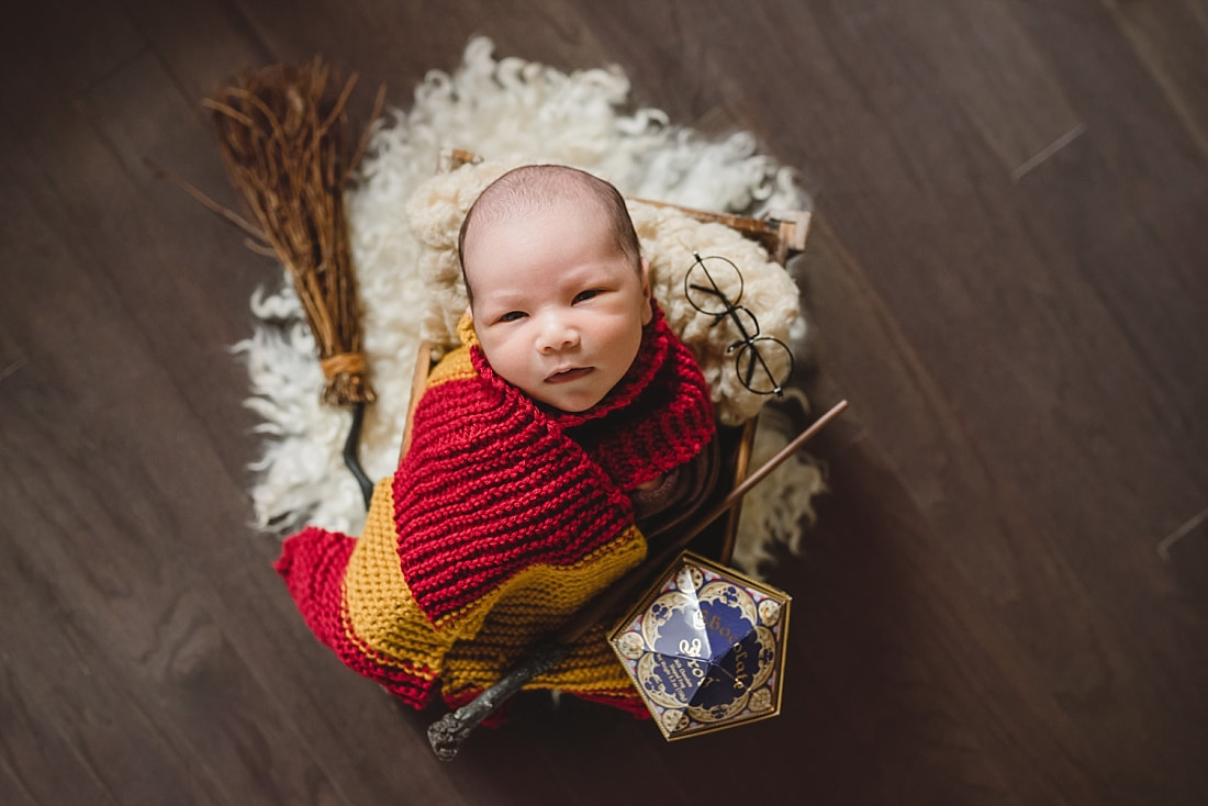 newborn baby boy dressed up as Harry Potter during newborn photo shoot in Memphis, TN
