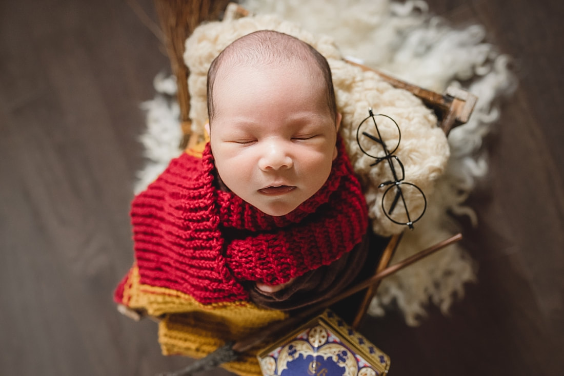 newborn baby boy dressed up as Harry Potter during newborn photo shoot in Memphis, TN