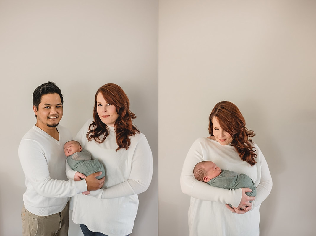 new family of three, mom and dad holding newborn baby boy during newborn photos in memphis tn