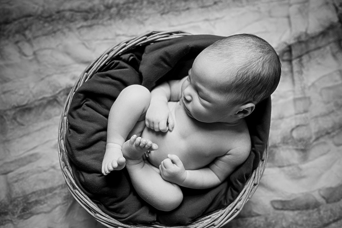 adorable newborn baby boy wearing a gray bonnet during memphis newborn photo shoot