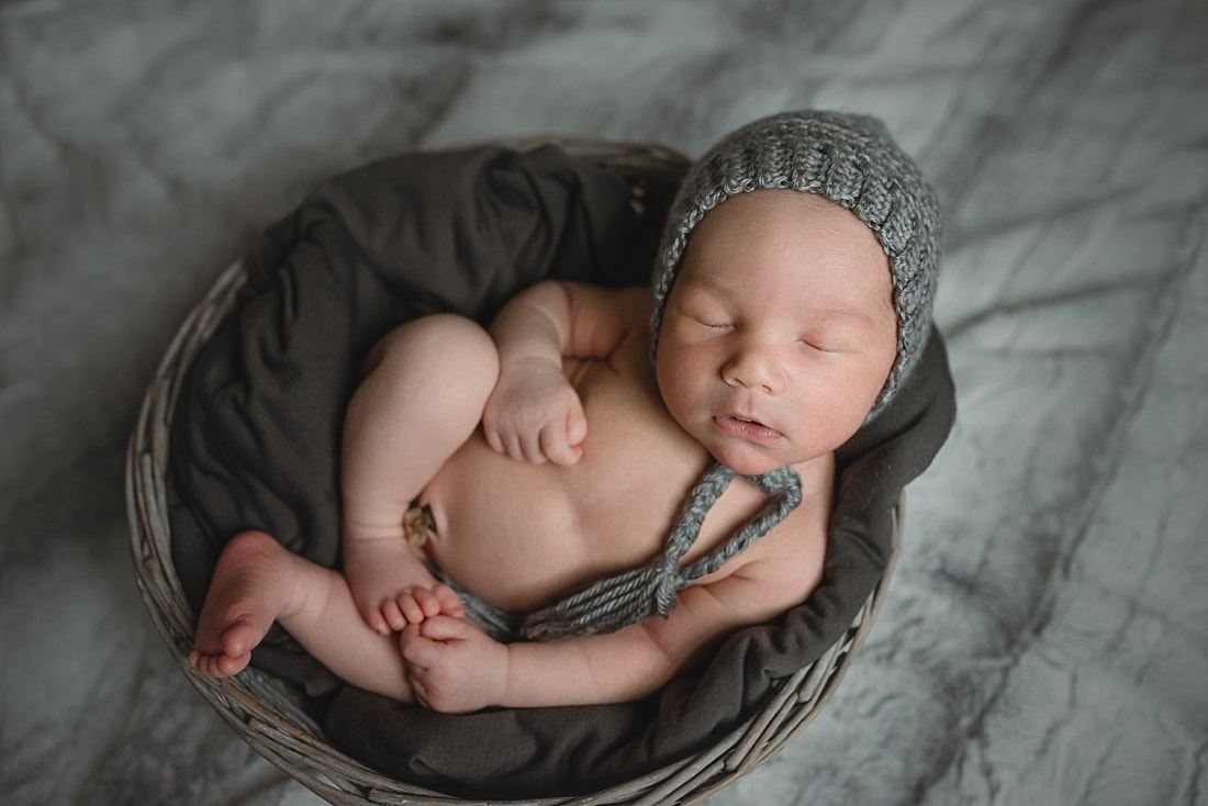 adorable newborn baby boy wearing a gray bonnet during newborn photo shoot + memphis