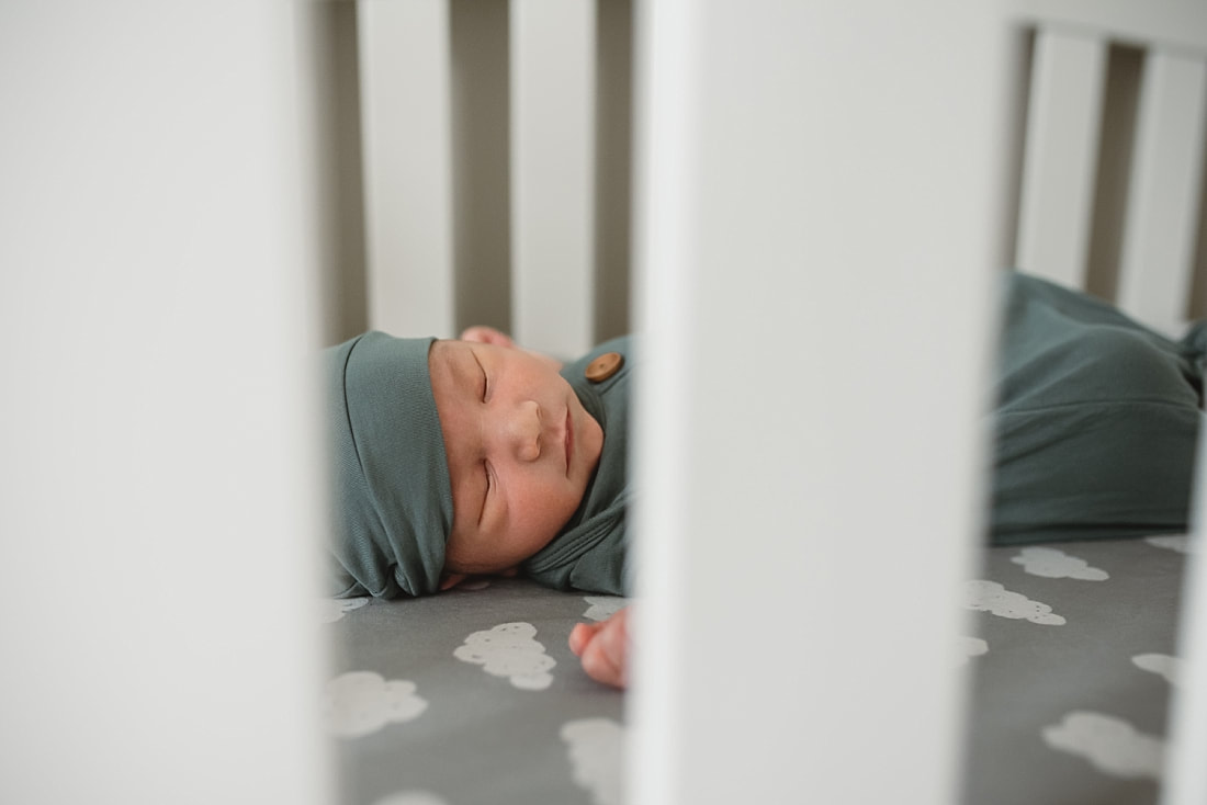 newborn baby boy sleeping in crib during newborn photos in memphis