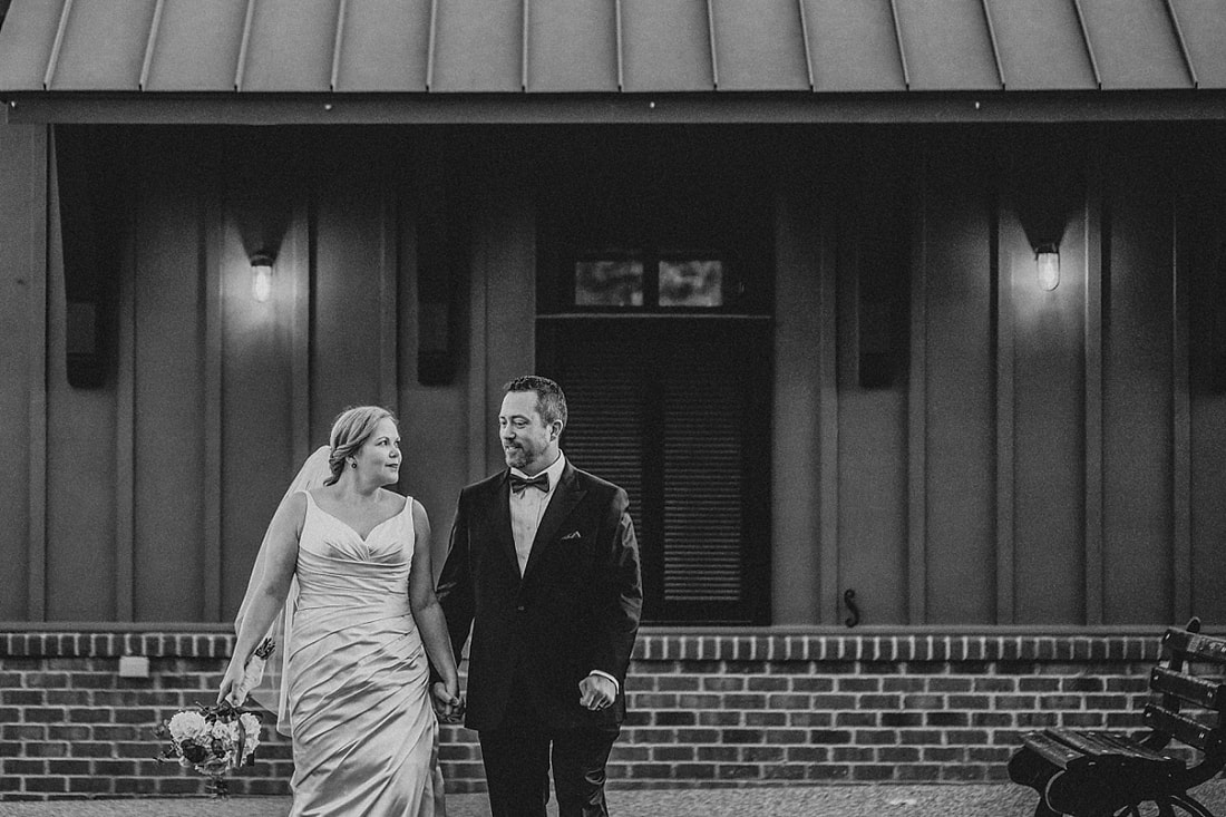 bride and groom walking hand in hand at the Collierville Town Square