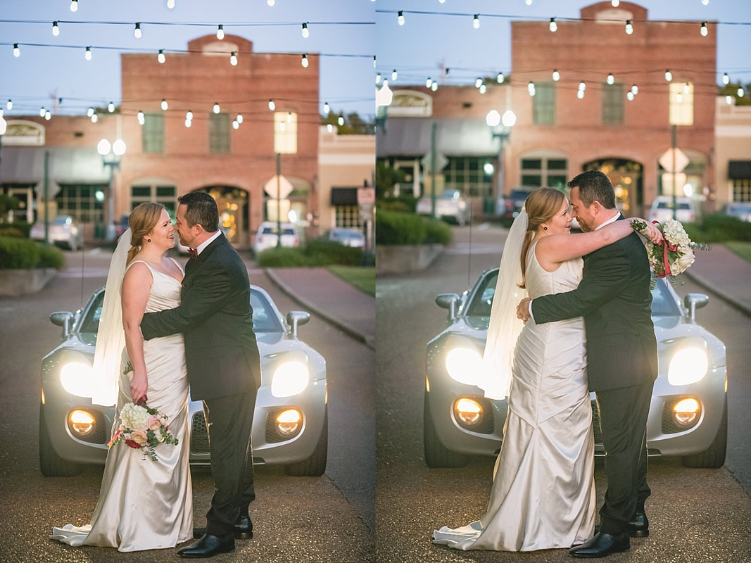 bride and groom kissing in front of their wedding getaway car at the Collierville Town Square