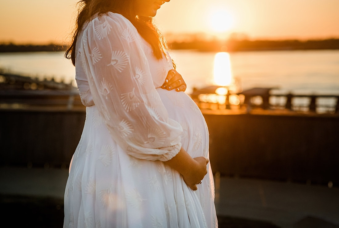 pregnant mother at sunset by mississippi river