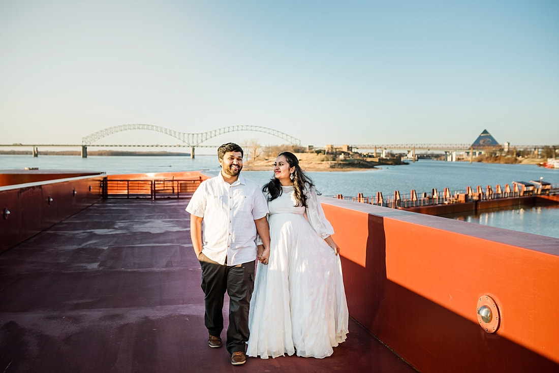 maternity photos at the mississippi river with the memphis skyline in the background