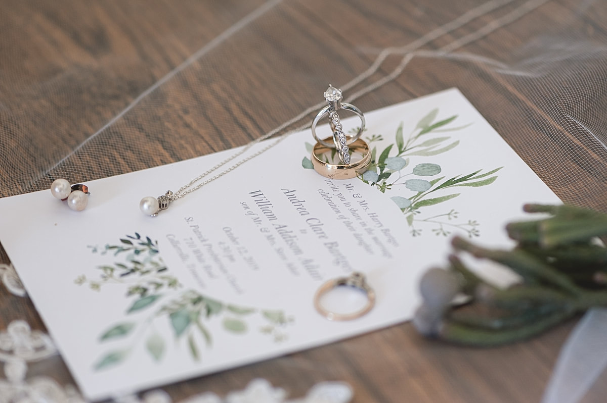 wedding rings and wedding pearl necklace on the wedding invitation