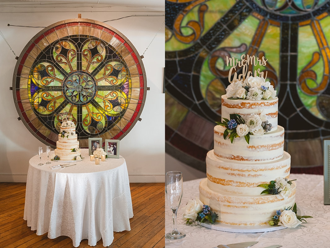 the wedding cake table in front of a beautiful stained glass window at the robinson gallery downtown memphis
