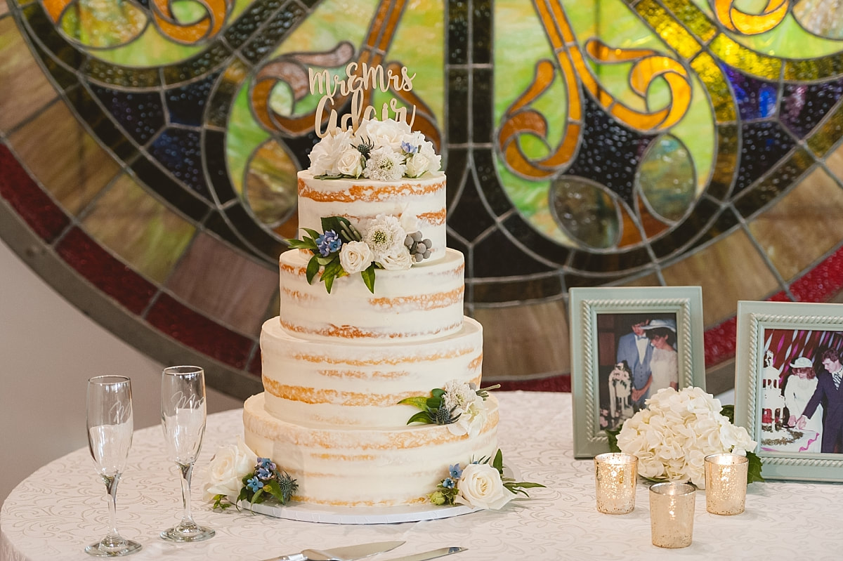 the wedding cake table in front of a beautiful stained glass window at the robinson gallery downtown memphis