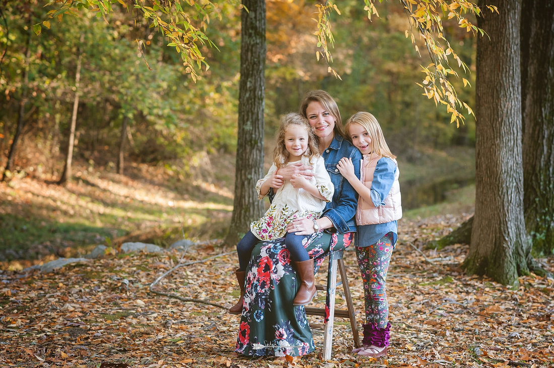 family portrait in the fall leaves on walking trail in collierville, tn