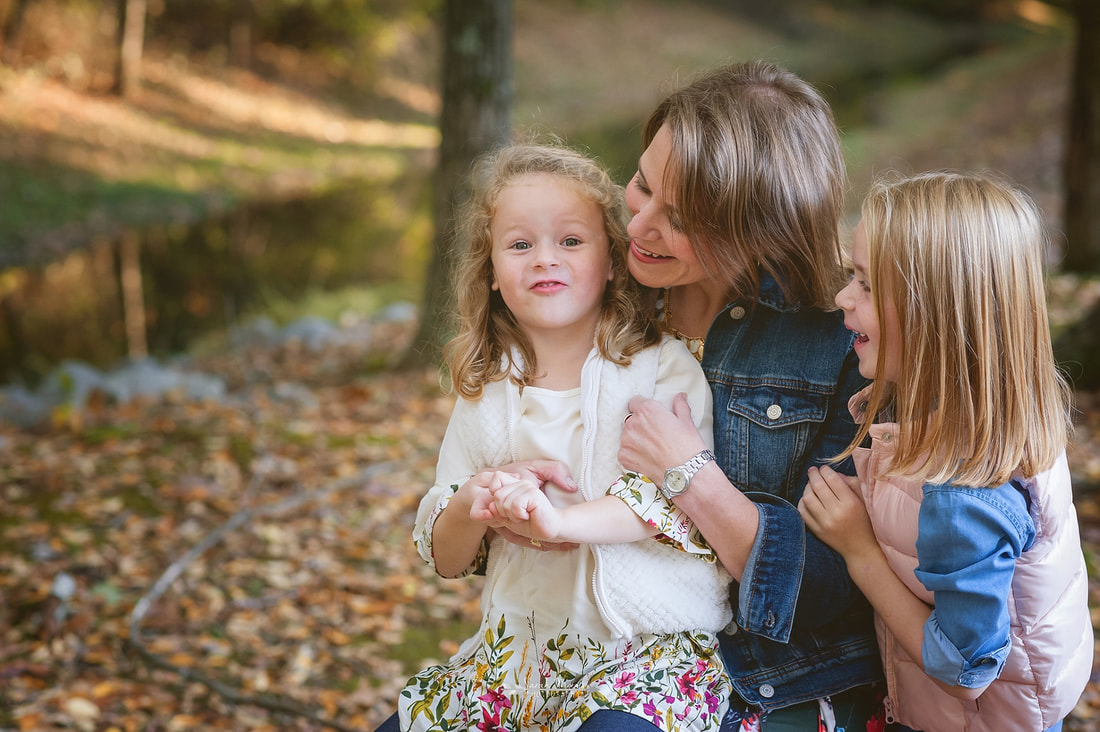little girl making silly faces during fall family photos