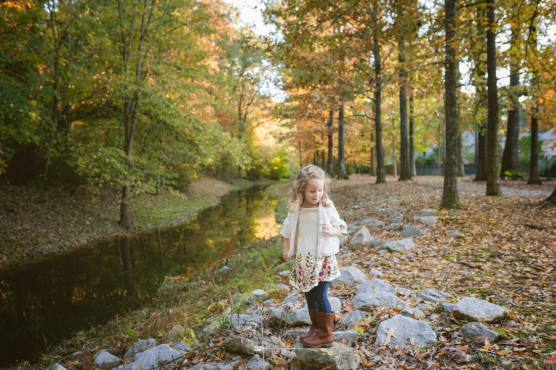 child playing on the banks of the creek in collierville