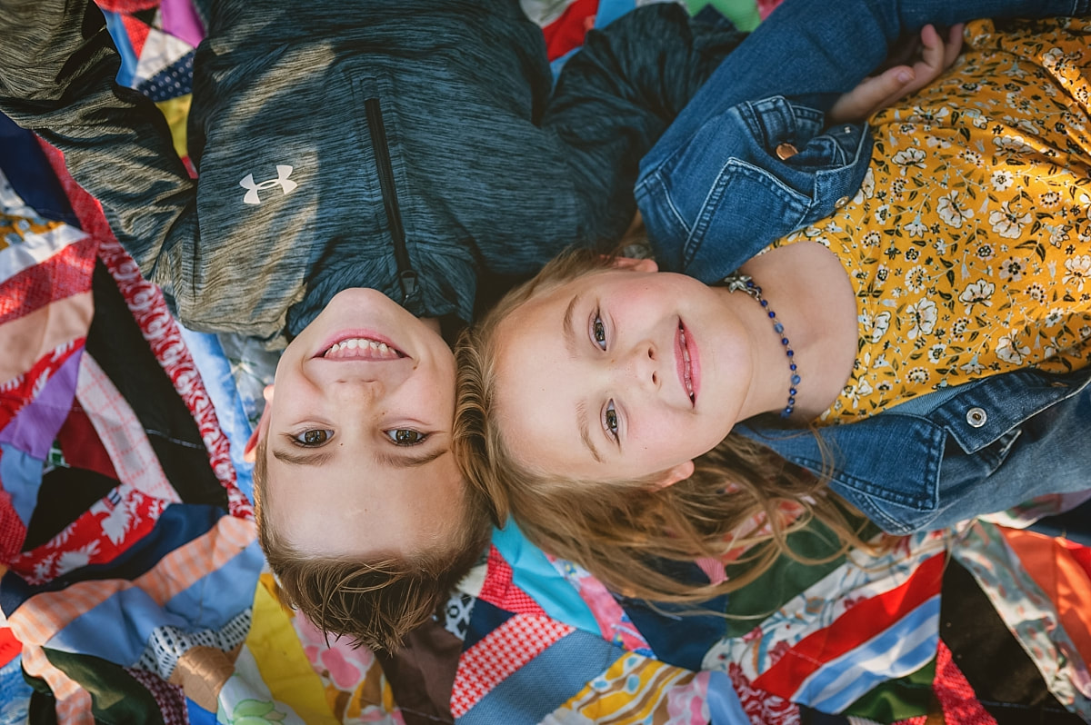 kids on a vintage quilt during family photos in collierville, tn