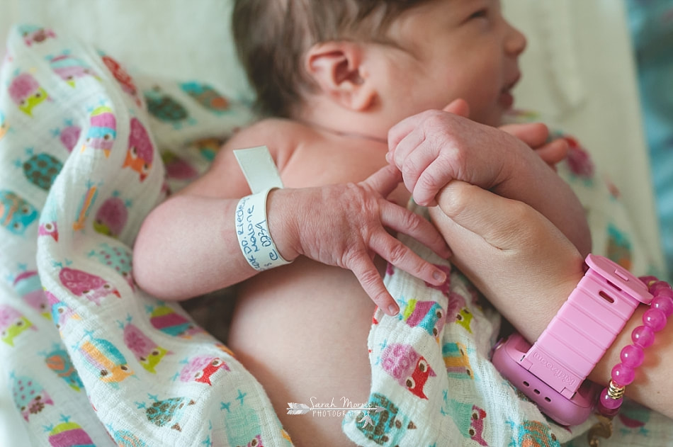 big sister holding newborn baby sister's hand at Methodist Le Bonheur Germantown Hospital