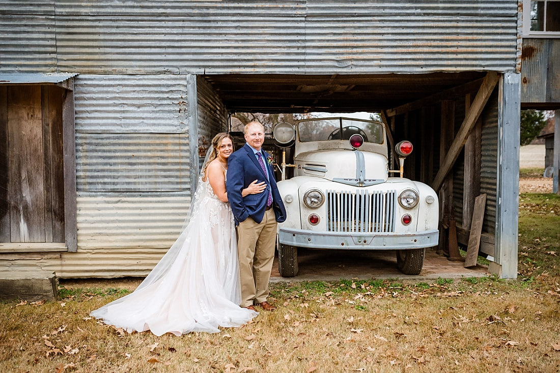 Bride and groom wedding photos in front of an old antique ford truck at Green Frog Farm