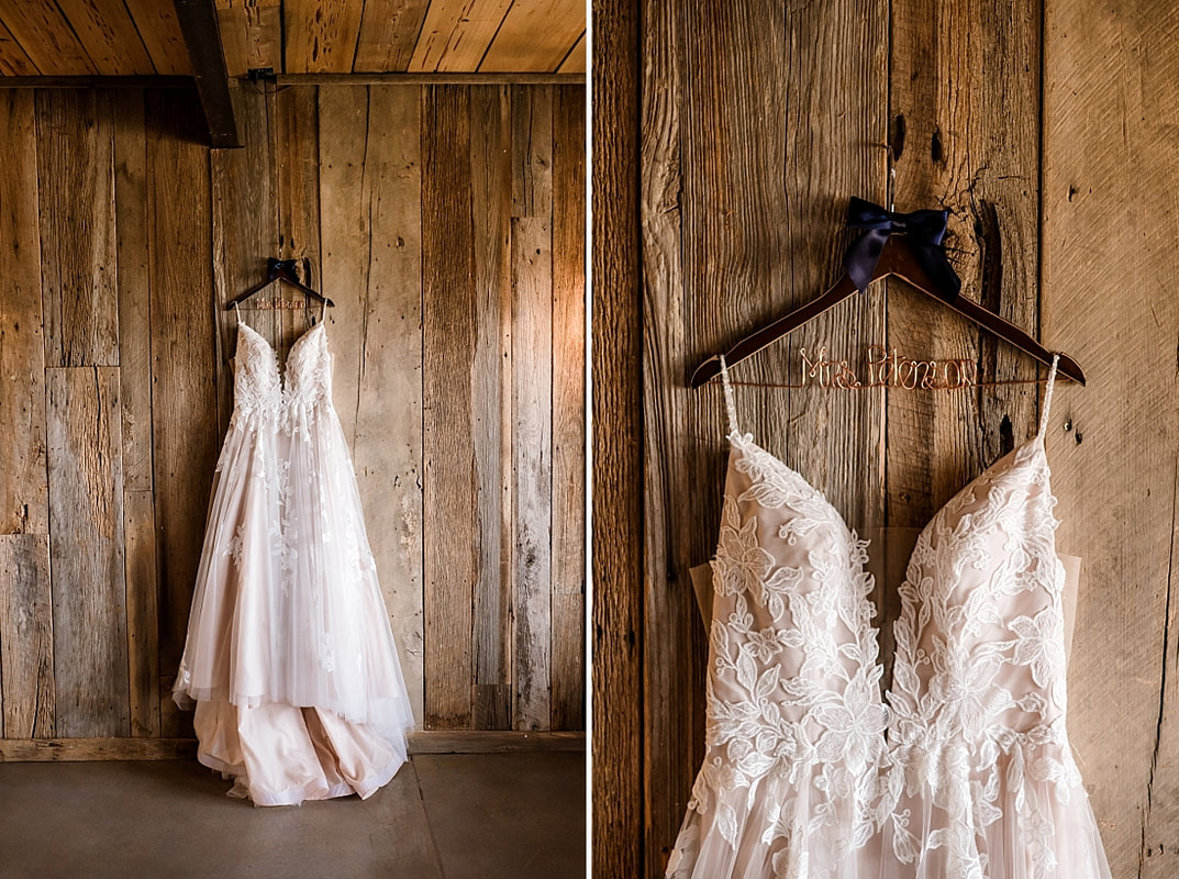 wedding dress hanging on the old rustic barn wall of green frog farm