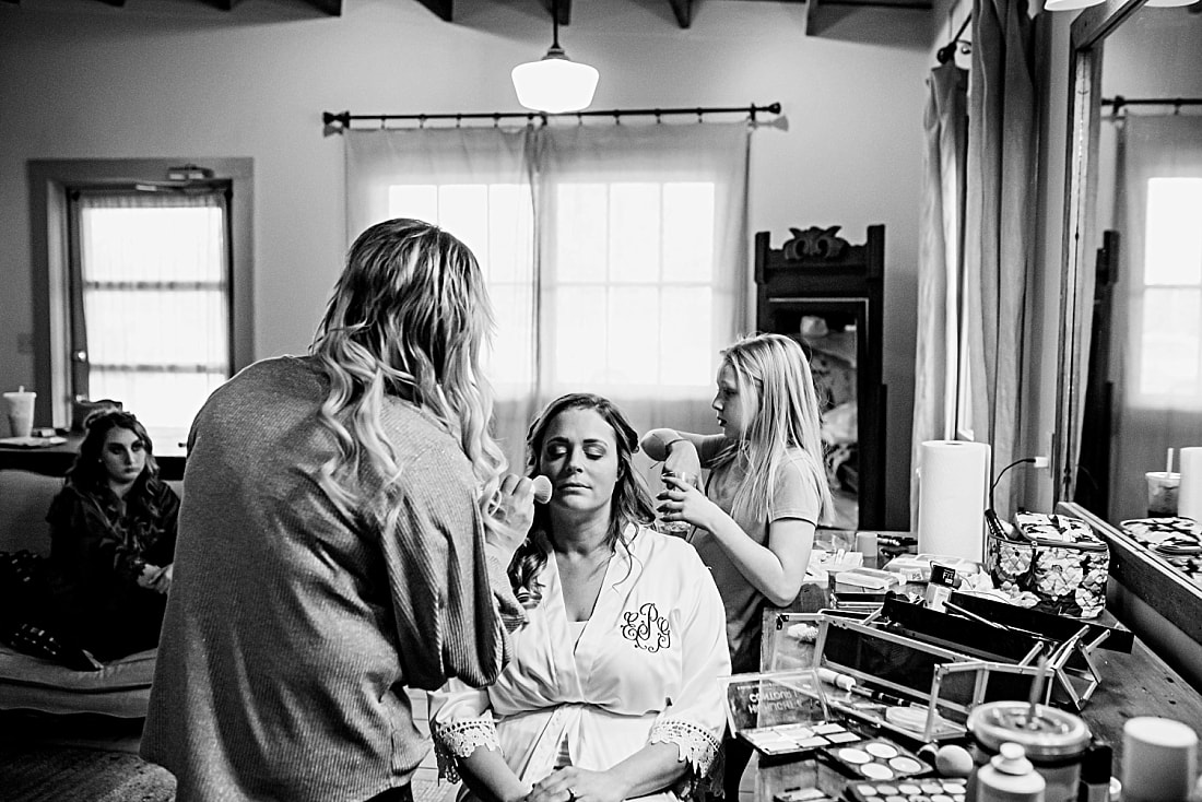 bride having her makeup done before wedding at green frog farm