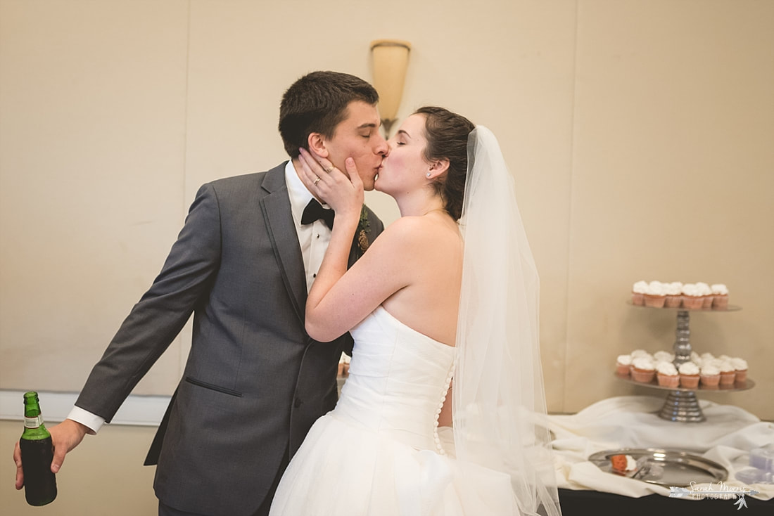 bride and groom kissing after cake cutting at memphis botanic garden