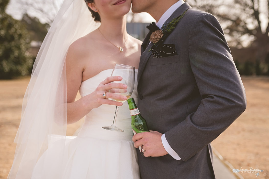 the bride and groom sharing a toast at memphis botanic garden
