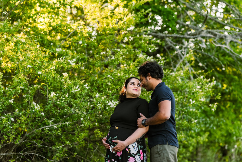 mother and father posing for maternity photos at Shelby Farms in Memphis, TN
