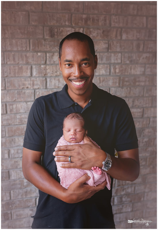 newborn photos of baby girl in daddy's hands