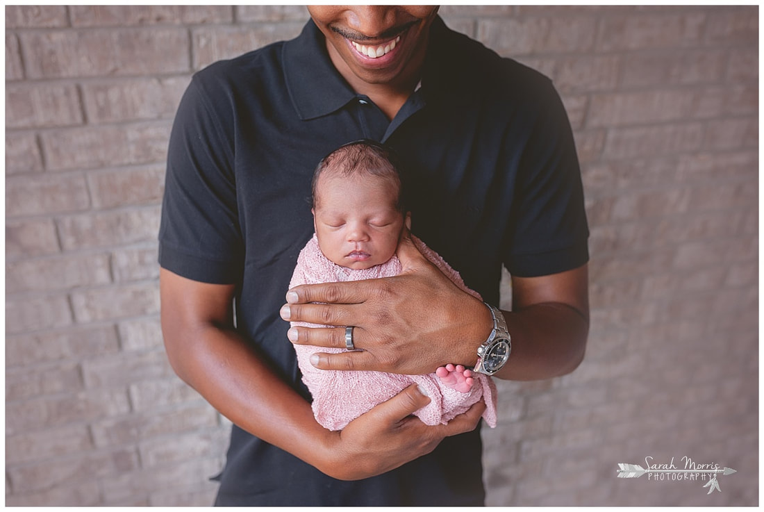 newborn photos of baby girl in daddy's hands