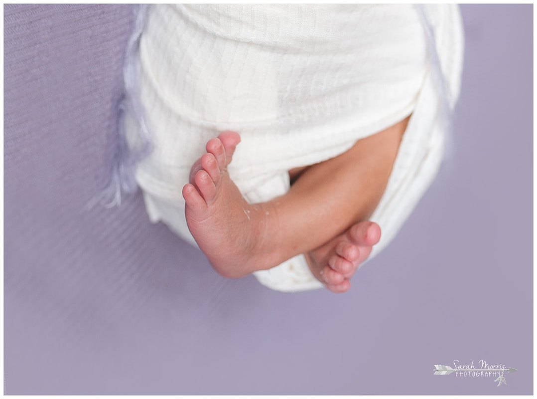 newborn photos of baby girl feet on purple blanket