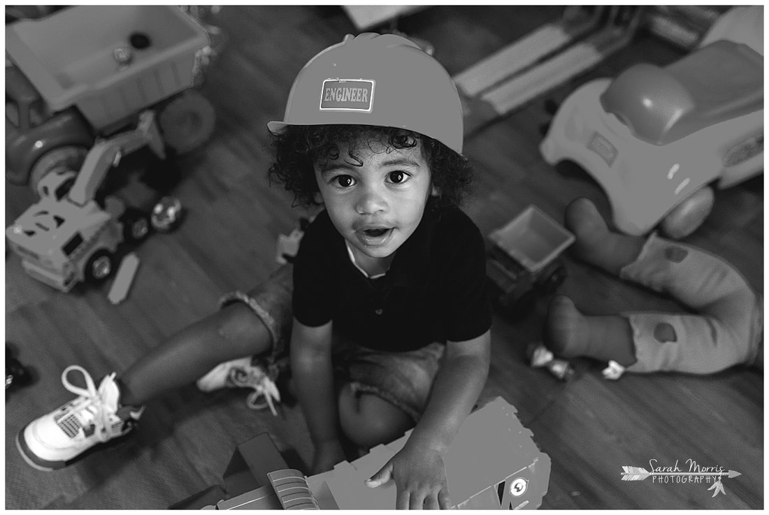 lifestyle portrait of toddler boy playing with toys