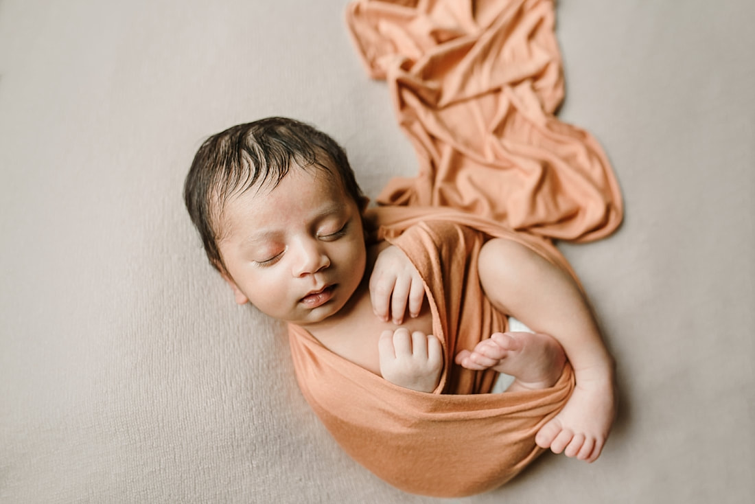 Newborn baby boy wrapped swaddled for newborn photoshoot in Collierville
