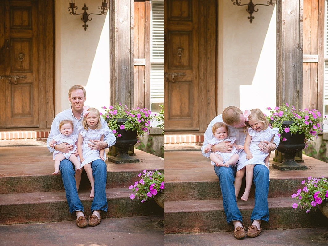 father holding his daughters on the front porch steps during in home lifestyle family session in collierville, tn