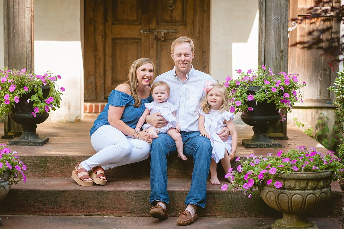 family portrait on the front porch steps during in home lifestyle family session in collierville, tn