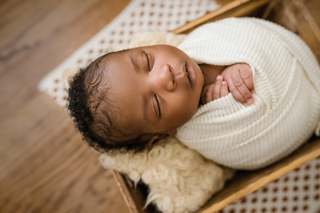 newborn baby sleeping in wooden box for newborn session with sarah morris photography