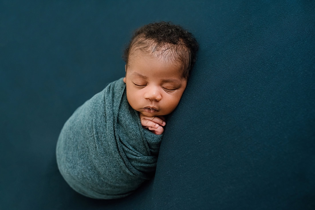 newborn baby wrapped in blue for newborn session in Memphis, TN