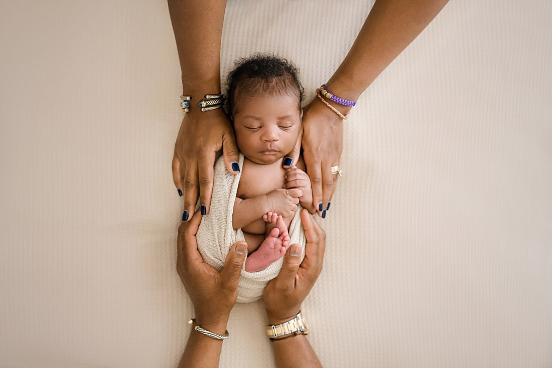 newborn baby with mom and dad's hands for newborn session in Memphis, TN