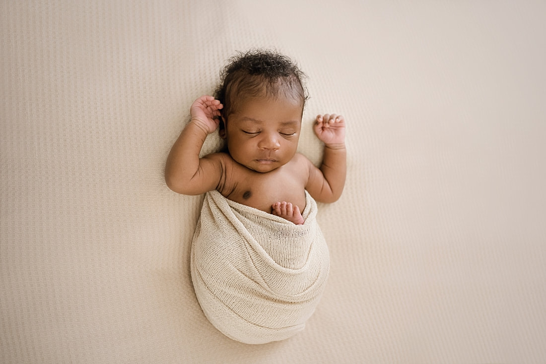 newborn baby wrapped in tan for newborn session in Memphis, TN