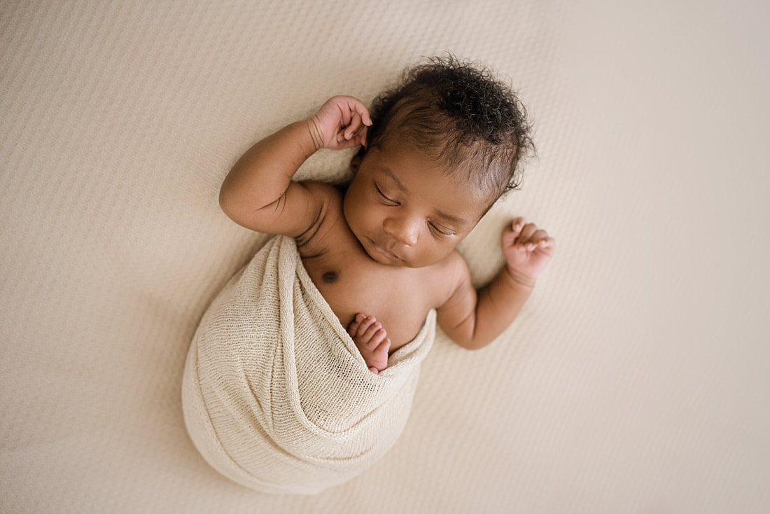 newborn baby wrapped in tan for newborn session in Memphis, TN