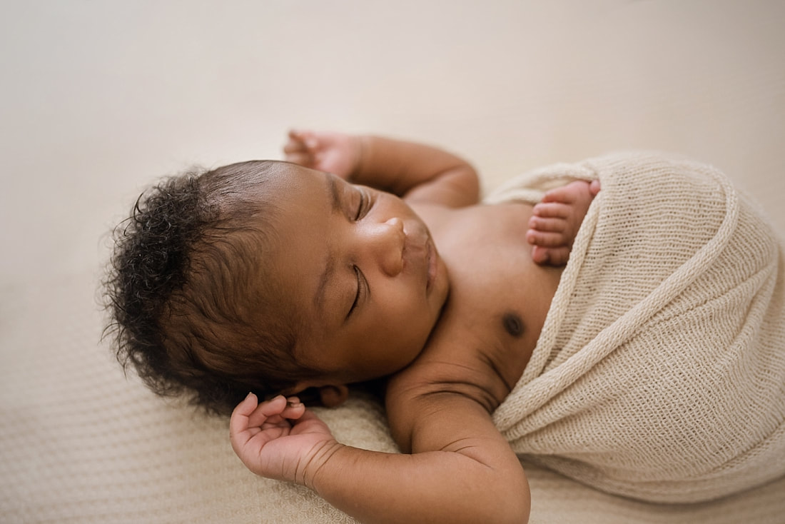 baby boy sleeping on tan blanket for newborn photos in Collierville, TN