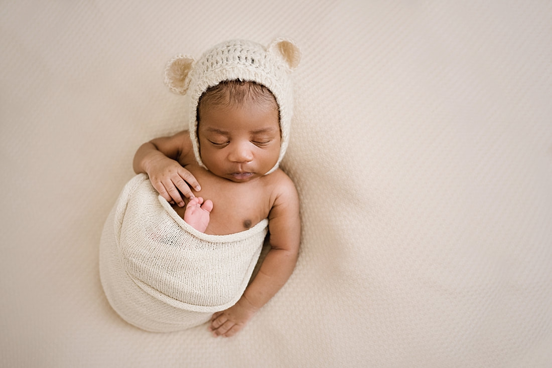 newborn baby wearing teddy bear bonnet for newborn photos in Collierville, TN