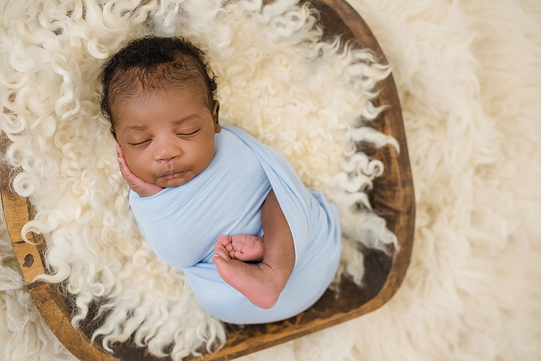 Picture of newborn baby boy wrapped in blue