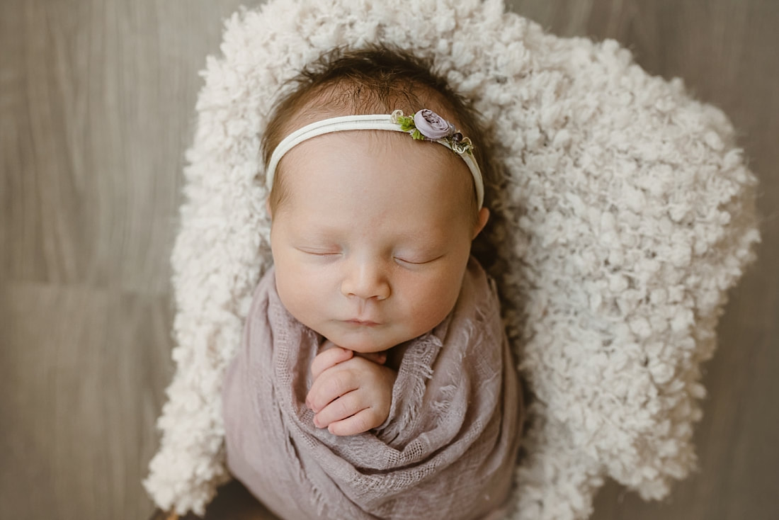 baby girl swaddled in mauve blanket for newborn photography in Memphis, TN