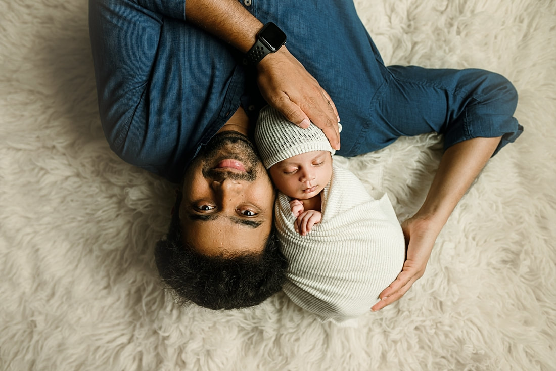 Newborn baby boy swaddled held by dad for newborn portrait in Memphis, TN