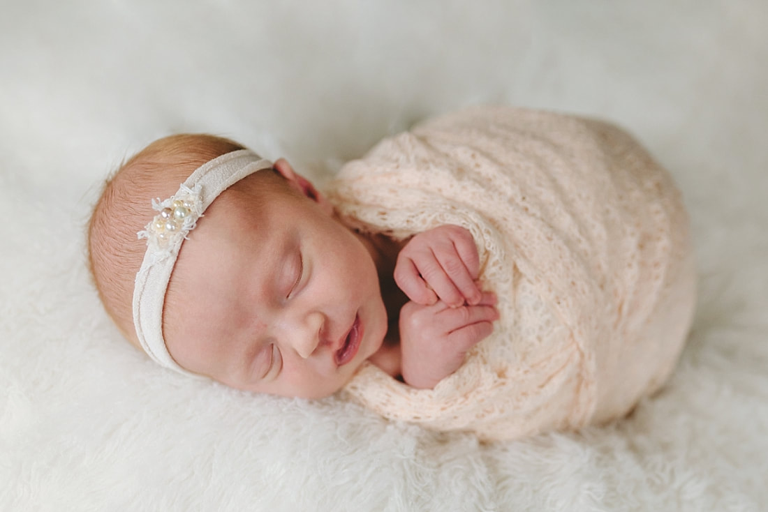 newborn baby girl swaddled for newborn photoshoot in Memphis, TN