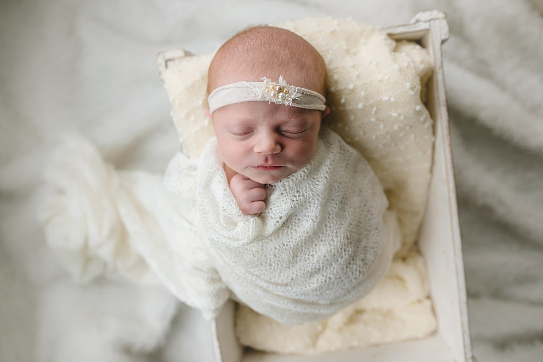 newborn baby girl swaddled in prop for newborn photoshoot in Memphis, TN