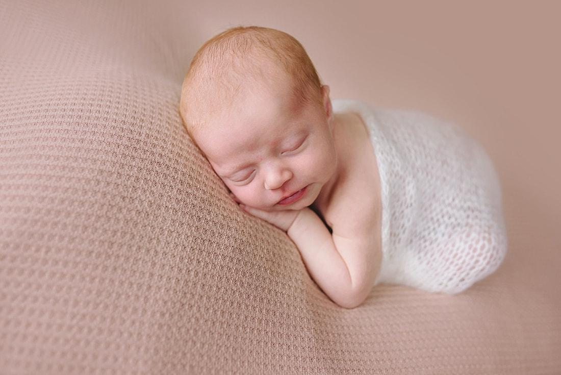 newborn baby sleeping on pink blanket for newborn photoshoot in Memphis, TN