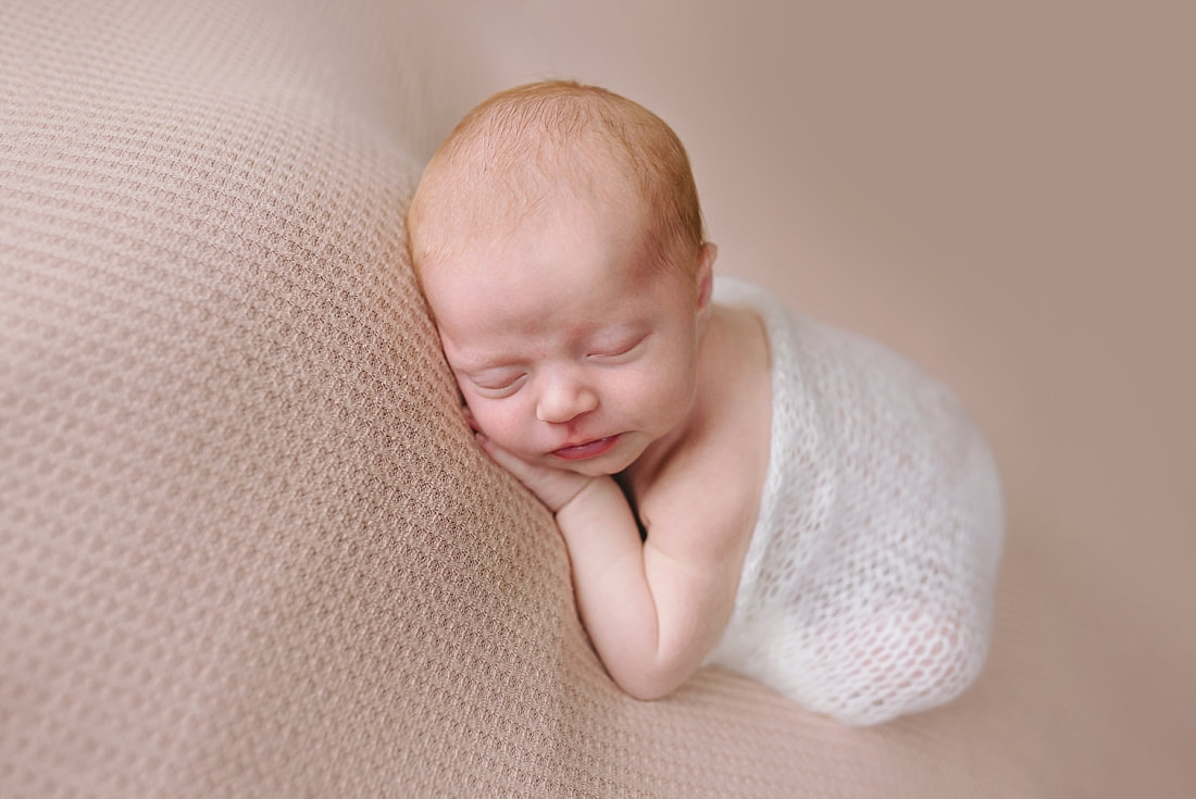 newborn baby sleeping on pink blanket for newborn photoshoot in Memphis, TN