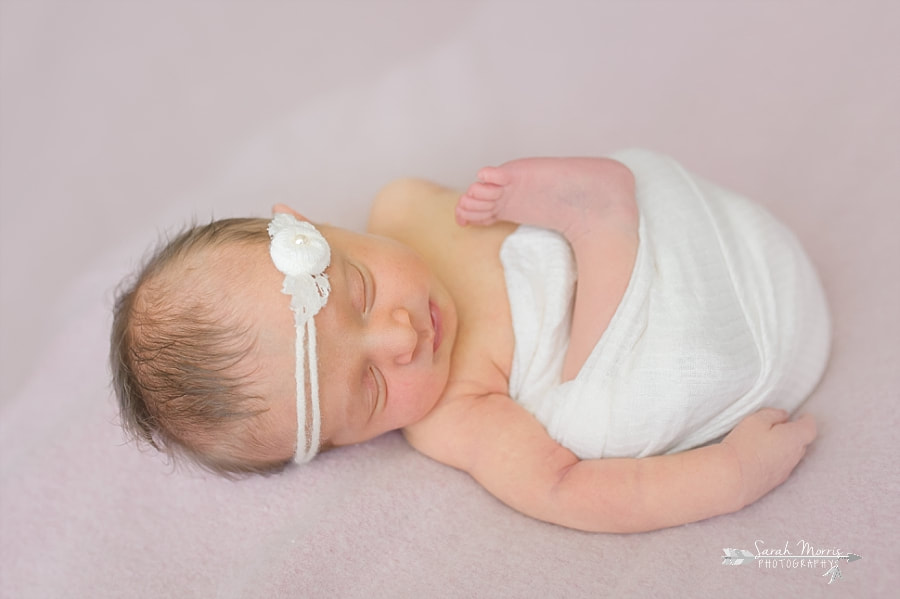 PictureNewborn Photography | Newborn Baby girl posed on pink blanket at Newborn Photo Session in Memphis, TN